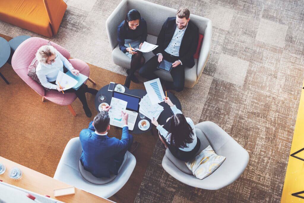 Informal meeting with people discussing ideas in an office space.